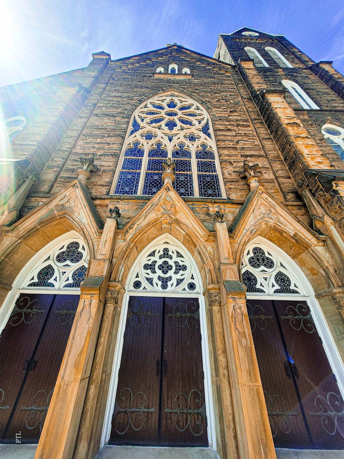 Triple Gothic entrance portals beneath the rose window at St. Mary's